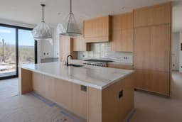 Kitchen cabinets being installed, still under protective wrap